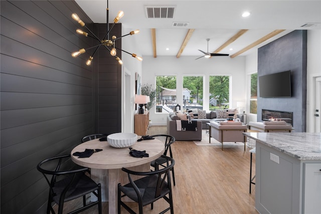 dining area featuring beamed ceiling, visible vents, and light wood-style floors