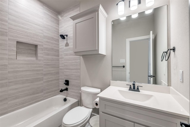 bathroom featuring a textured wall, toilet, vanity, and shower / tub combination