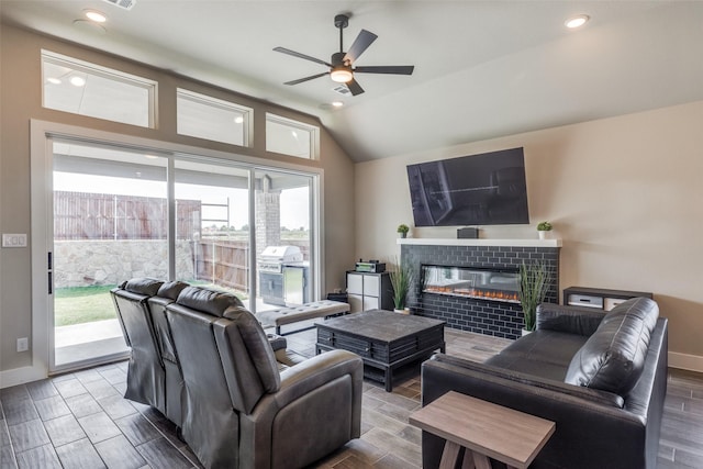 2308 Flock Dr, Mansfield, TX 76063 - living area with ceiling fan, lofted ceiling, a tile fireplace, wood finish floors, and baseboards