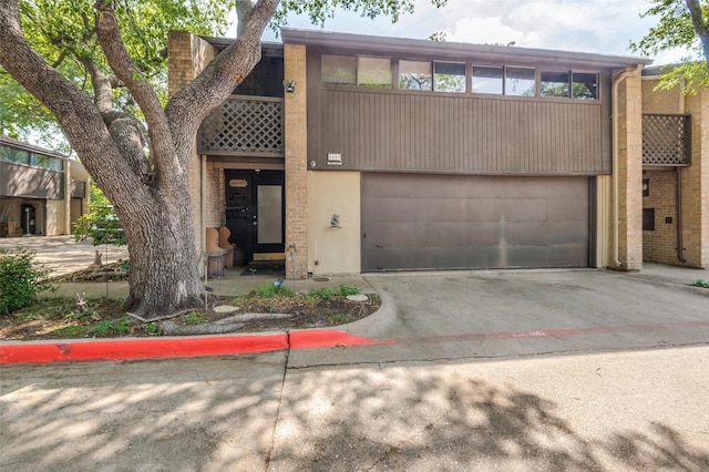 multi unit property with a garage and concrete driveway