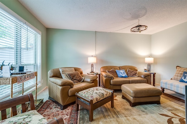 carpeted living area featuring a textured ceiling