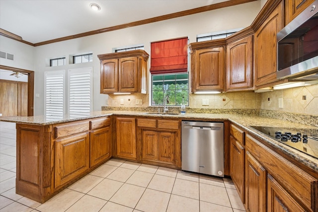 845 Canyon Crest Dr, Irving, TX 75063 - kitchen featuring crown molding, tasteful backsplash, a sink, a peninsula, and appliances with stainless steel finishes