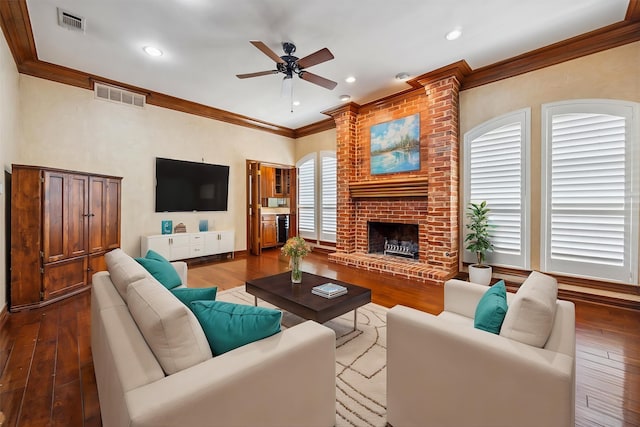 845 Canyon Crest Dr, Irving, TX 75063 - living room featuring dark wood finished floors, visible vents, a ceiling fan, and ornamental molding