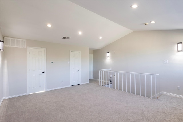 carpeted empty room featuring baseboards, visible vents, and recessed lighting