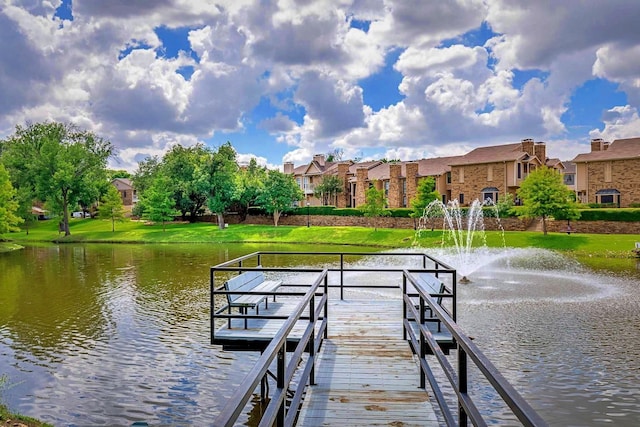 dock area with a yard, a residential view, and a water view