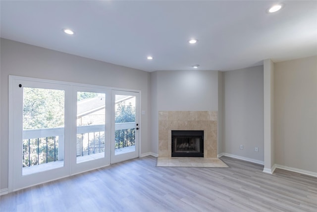 unfurnished living room featuring recessed lighting, light wood finished floors, and baseboards