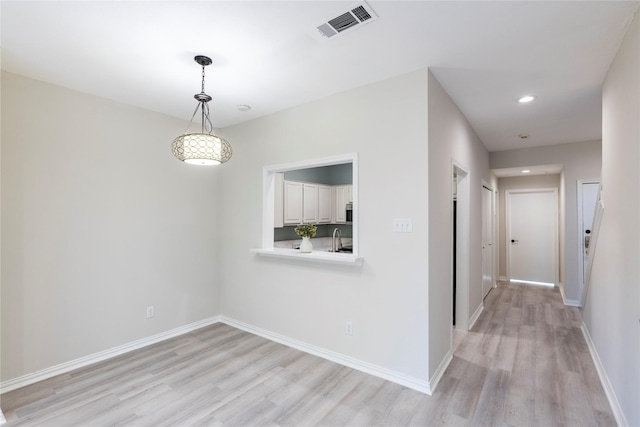 unfurnished dining area with recessed lighting, baseboards, visible vents, and light wood-type flooring