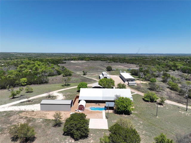drone / aerial view featuring a view of trees