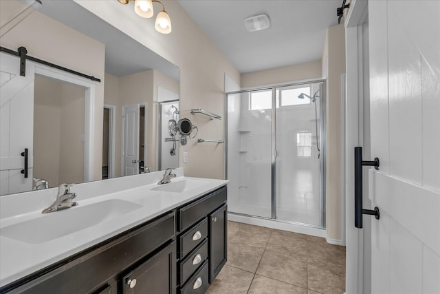 full bath with a shower stall, double vanity, and tile patterned floors