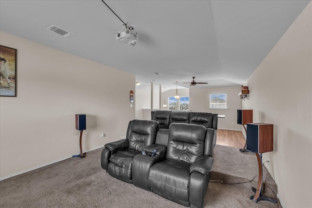 home theater room featuring ceiling fan, baseboards, and carpet