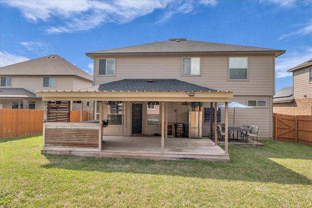 back of property featuring a patio and a shingled roof