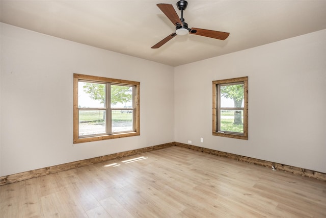 1754 County Road 427, Muenster, TX 76252 - spare room with light wood-style flooring, baseboards, a wealth of natural light, and a ceiling fan