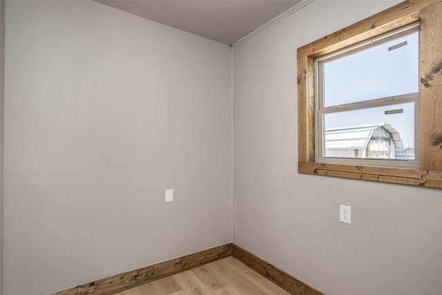 1754 County Road 427, Muenster, TX 76252 - unfurnished room with baseboards, crown molding, and light wood-style floors