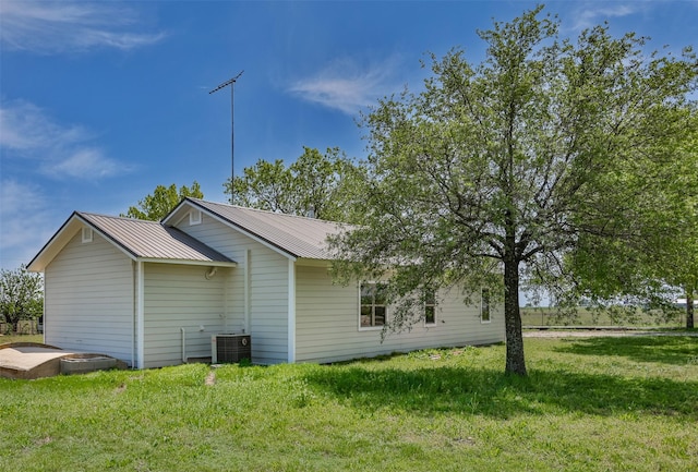 1754 County Road 427, Muenster, TX 76252 - view of property exterior with a lawn, central AC unit, and metal roof