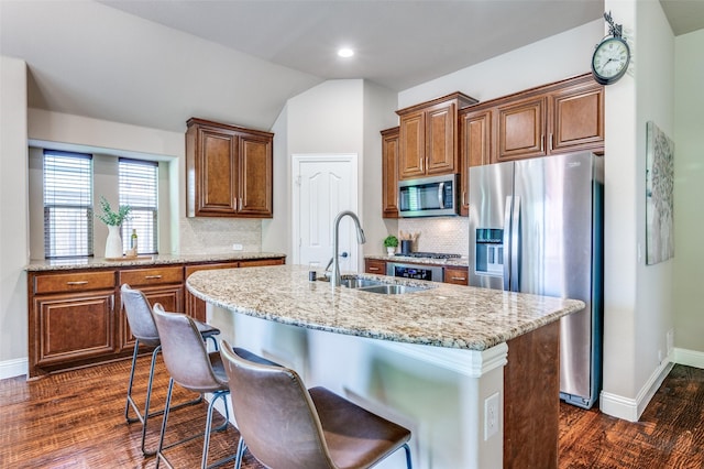 11529 Penick Way, Frisco, TX 75033 - kitchen featuring appliances with stainless steel finishes, a sink, dark wood-type flooring, a kitchen island with sink, and baseboards