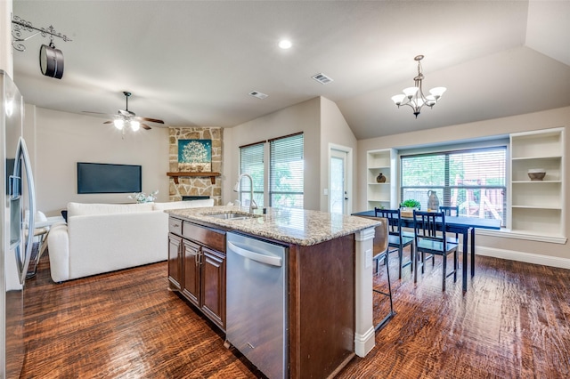 11529 Penick Way, Frisco, TX 75033 - kitchen featuring stainless steel appliances, a sink, a chandelier, light stone countertops, and a ceiling fan