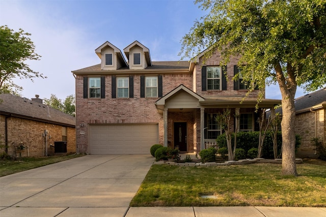 5720 Rubblestone Dr, Mckinney, TX 75070 - view of front facade with brick siding, an attached garage, a front yard, concrete driveway, and covered porch
