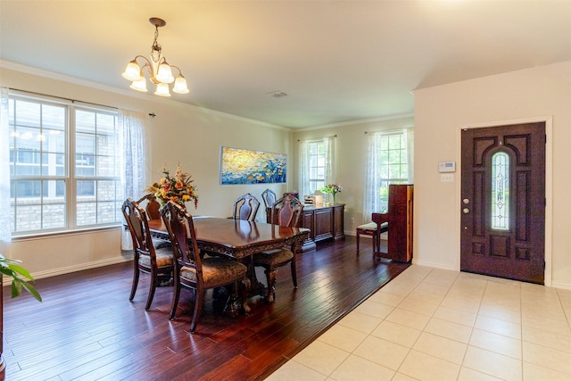 5720 Rubblestone Dr, Mckinney, TX 75070 - dining room with a chandelier, plenty of natural light, crown molding, wood finished floors, and baseboards