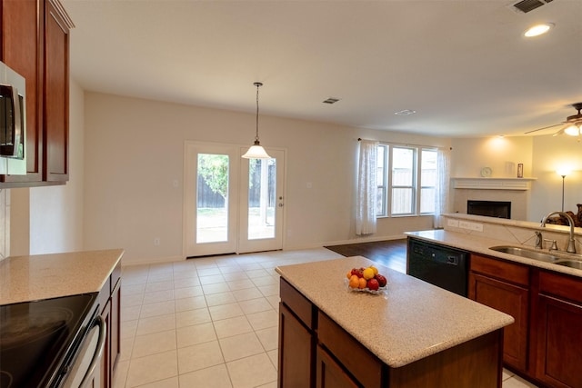 5720 Rubblestone Dr, Mckinney, TX 75070 - kitchen featuring a sink, open floor plan, dishwasher, a fireplace, and light tile patterned floors