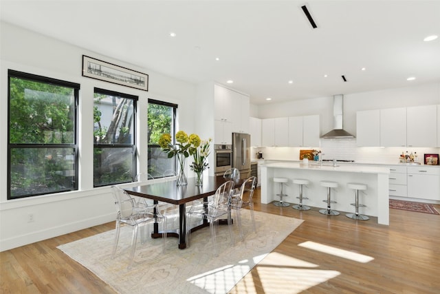 dining area featuring recessed lighting and light wood-type flooring