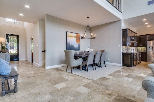105 Bay Hill Dr, Graford, TX 76449 - dining space featuring a chandelier, baseboards, recessed lighting, light stone finish flooring, and a high ceiling