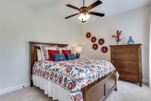 bedroom featuring a ceiling fan, baseboards, and light carpet