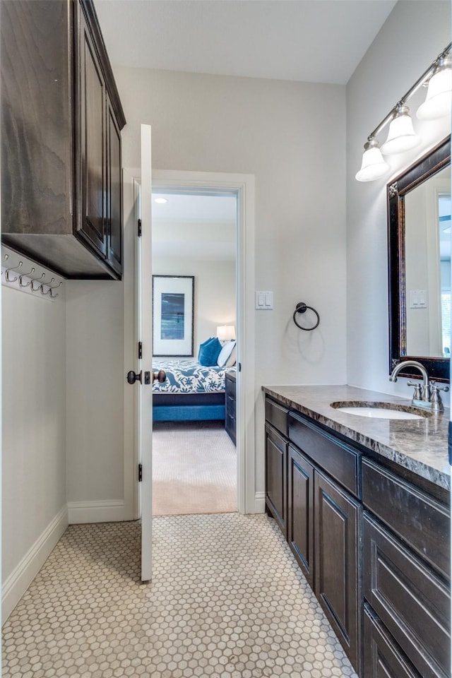 bathroom featuring baseboards and vanity