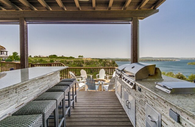 105 Bay Hill Dr, Graford, TX 76449 - wooden terrace featuring exterior kitchen, a water view, and a grill