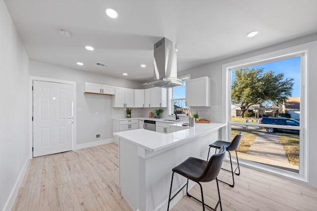 1826 Norfolk Ave, Dallas, TX 75203 - kitchen featuring island range hood, light wood finished floors, a sink, and visible vents