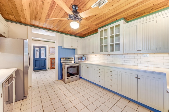 1182 County Road 3025, Bonham, TX 75418 - kitchen featuring light tile patterned floors, wood ceiling, stainless steel appliances, light countertops, and visible vents