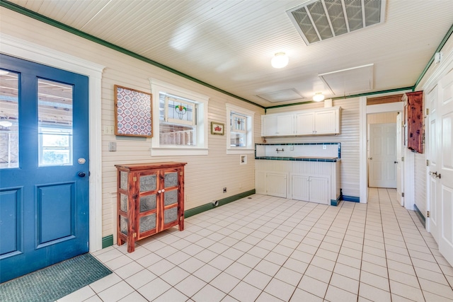 1182 County Road 3025, Bonham, TX 75418 - kitchen with white cabinets, baseboards, visible vents, and light tile patterned flooring