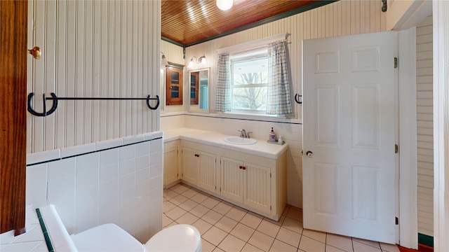 1182 County Road 3025, Bonham, TX 75418 - bathroom with wooden ceiling, toilet, vanity, and tile patterned floors