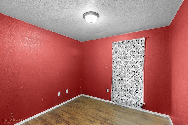 5663 Bretwood Dr, Keithville, LA 71047 - unfurnished room featuring baseboards, wood finished floors, and a textured ceiling