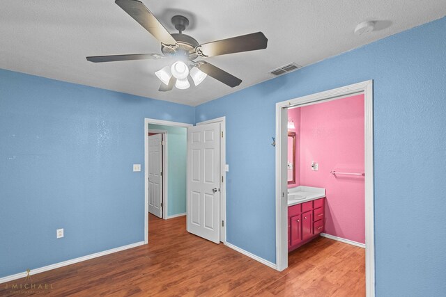5663 Bretwood Dr, Keithville, LA 71047 - unfurnished bedroom with visible vents, a ceiling fan, light wood-style floors, baseboards, and ensuite bathroom