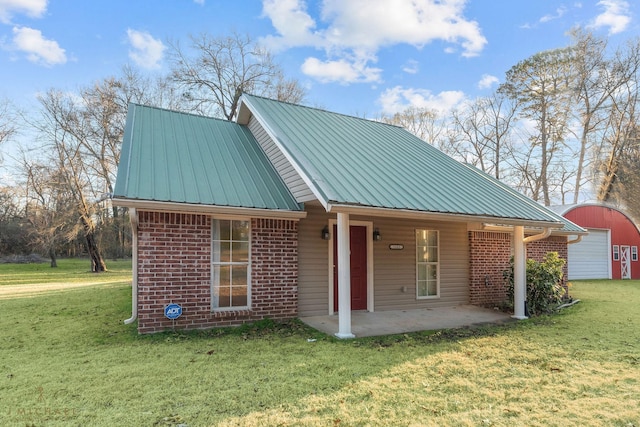 5663 Bretwood Dr, Keithville, LA 71047 - view of front of home with a garage, brick siding, a front yard, and metal roof