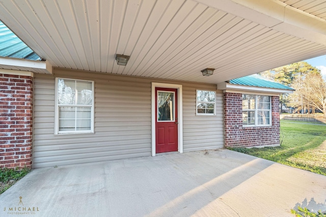 5663 Bretwood Dr, Keithville, LA 71047 - doorway to property with brick siding, a yard, and a patio
