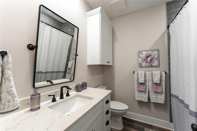 full bathroom featuring toilet, vanity, wood finished floors, and curtained shower