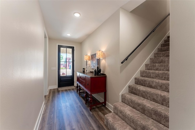 foyer featuring recessed lighting, baseboards, wood finished floors, and stairs