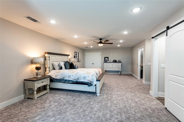 bedroom featuring visible vents, recessed lighting, carpet flooring, and a barn door