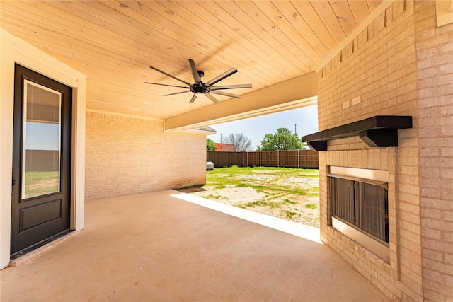 view of patio with fence and a ceiling fan