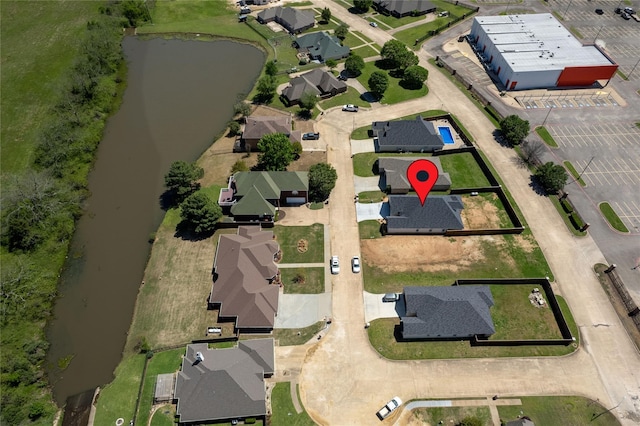 drone / aerial view with a residential view and a water view