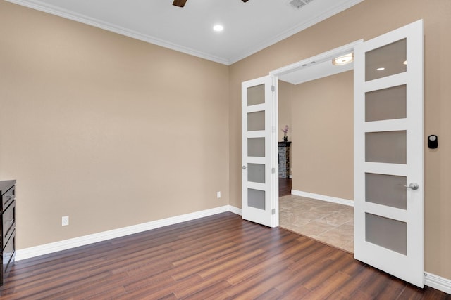 spare room with french doors, dark wood-style flooring, baseboards, ceiling fan, and ornamental molding