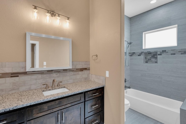 full bathroom featuring tile patterned floors, vanity, shower / washtub combination, backsplash, and toilet