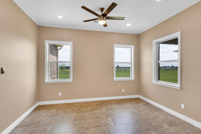 unfurnished room featuring a ceiling fan, baseboards, and crown molding