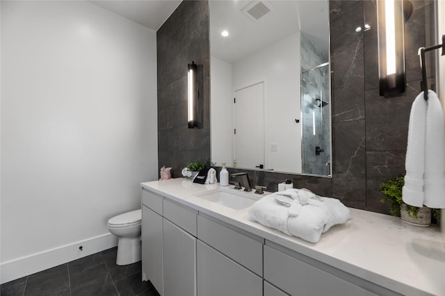 1124 Paradise Cv, Streetman, TX 75859 - bathroom featuring visible vents, toilet, vanity, baseboards, and a stall shower