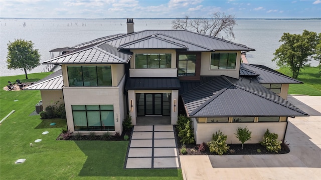 1124 Paradise Cv, Streetman, TX 75859 - view of front of property with a water view, a standing seam roof, a chimney, metal roof, and a front yard