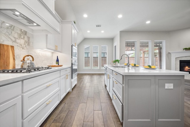 kitchen with a sink, dark wood-style flooring, visible vents, recessed lighting, and appliances with stainless steel finishes
