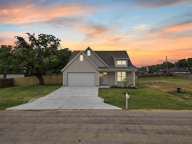 view of front facade featuring board and batten siding, fence, driveway, and a front yard