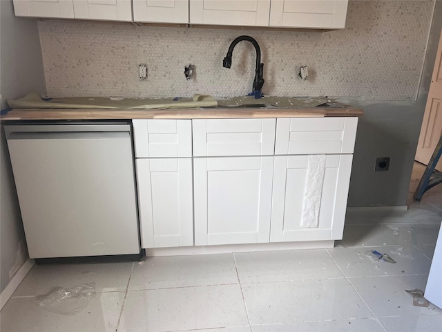 704 N Tennessee St, Mckinney, TX 75069 - interior space with white cabinets, tasteful backsplash, and stainless steel dishwasher