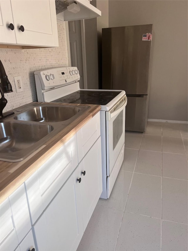704 N Tennessee St, Mckinney, TX 75069 - kitchen with white cabinets, under cabinet range hood, white range with electric stovetop, and light tile patterned flooring